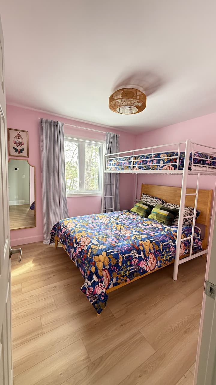 Main level bedroom with queen bed and a separate double loft