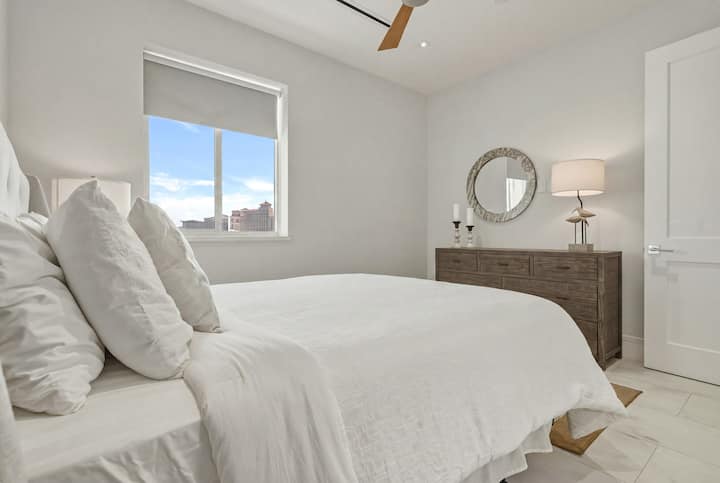 Bright second bedroom with a queen-size bed and relaxing, modern décor.