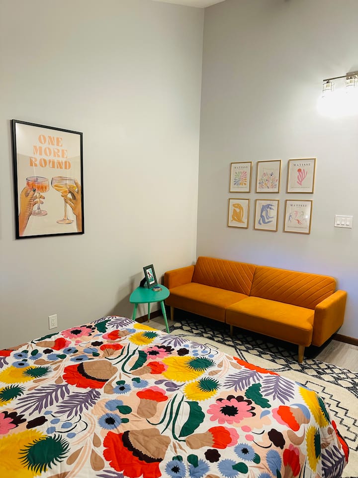 Orange couch folds down into a twin bed or roll the TV cart out of the closet for a second entertainment option.