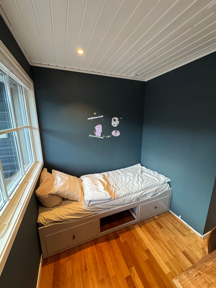 Dormitorio en el segundo piso con una cama de una plaza y acceso directo a la terraza orientada al sur.