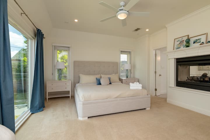 Luxurious master suite with a king bed and private fireplace.