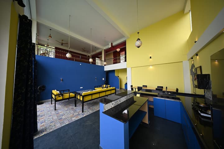 The main kitchen has all appliances: 4-burner, fridge, microwave, RO, cutlery and crockery. It is an island also.