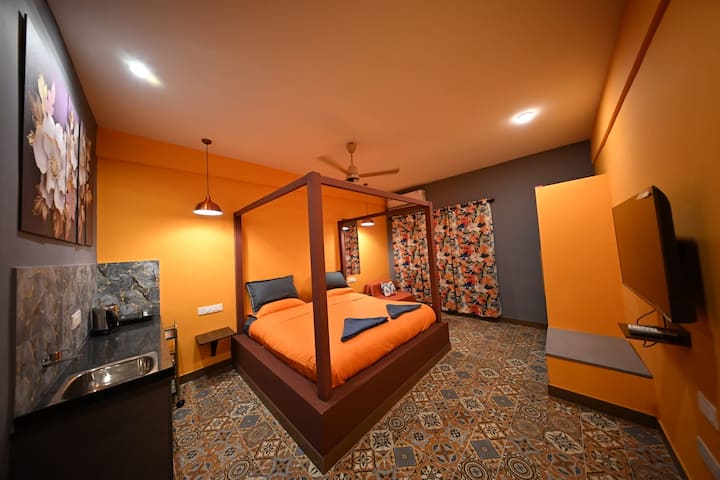 Bedroom 2 on the upper level has an attached bathroom,4 poster bed, foam mattress with soft duvets, wardrobe , LED TV, kitchenette -induction, hot water kettle & cutlery . It has an extra single guest sofabed. It opens to a huge balcony. Great view