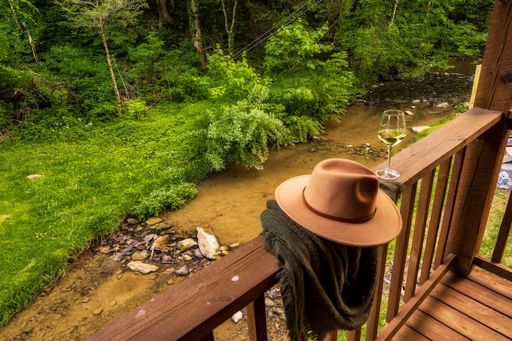 Covered deck space overlooking the creek and surrounding woods