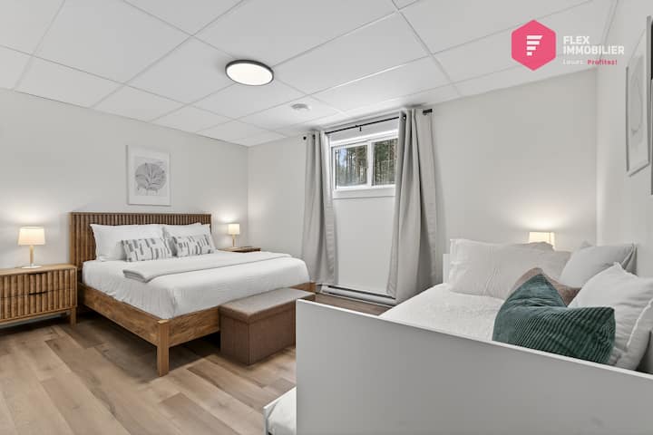 Comfortable bedroom #4 in the basement with 1 queen-size bed + 2 single beds