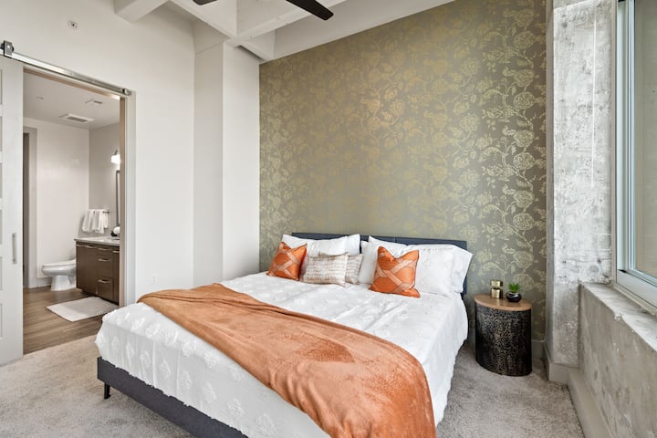 Rest easy in a peaceful, thoughtfully designed bedroom with soft linens and a cozy atmosphere. A perfect retreat to recharge after exploring the city.