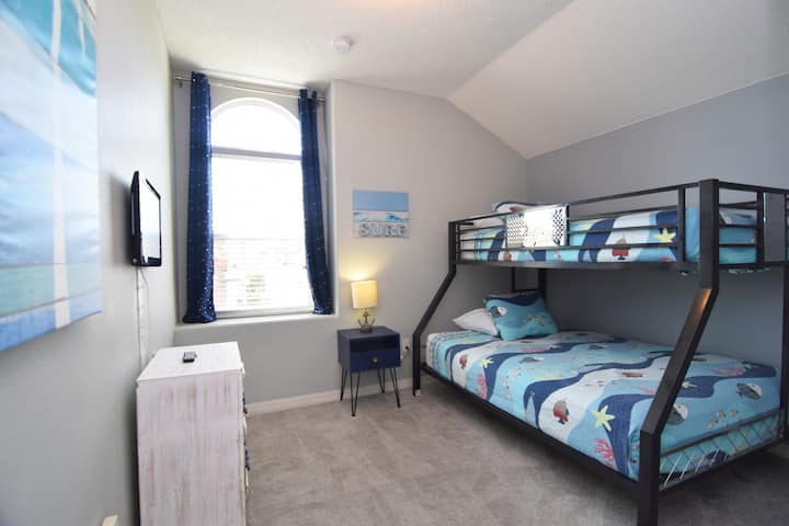 Bedroom 5 has a twin bunk bed for two guests with a TV