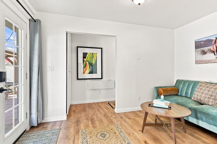 An additional space to unwind or sleep, with a sofa bed beside the glass door.