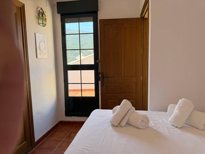 Puerta al balcón con la sierra de fondo: despertar con vistas