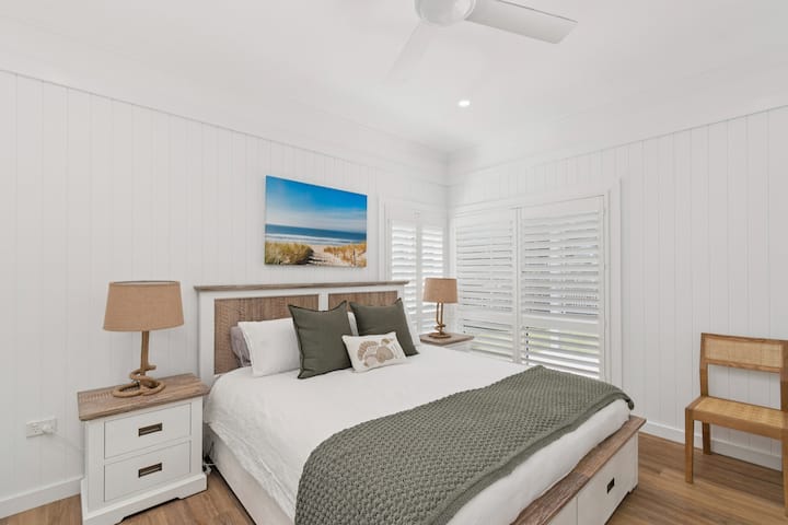 Unwind in the primary bedroom, where a king bed, ceiling fan, ample storage, and ensuite come together in a softly styled, restful setting.