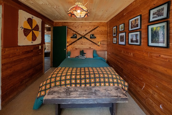 Bedroom 2  features a comfortable queen bed and a beautiful forest view