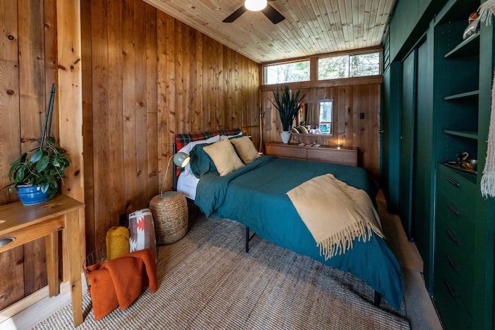 Bedroom 1: Unwind in a comfortable queen bedroom with a sleek sliding door closet for easy storage