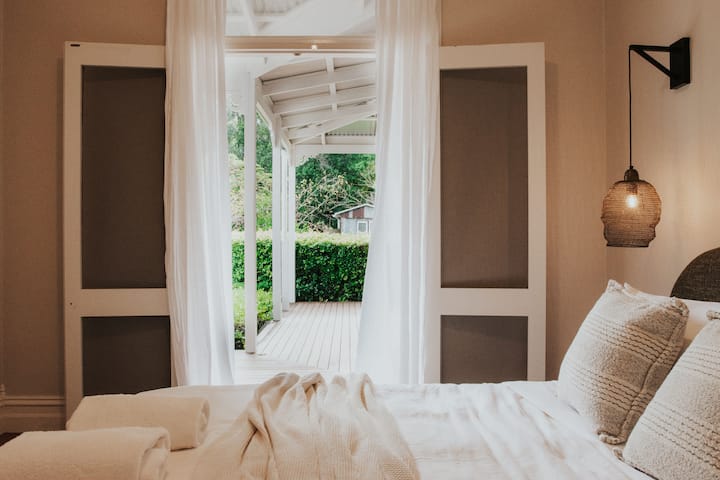 Queen room, French doors lead to wraparound veranda