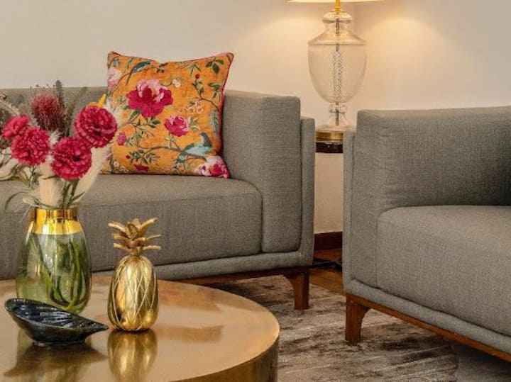 Whether you're lounging with a book, entertaining guests, or simply enjoying the tranquil surroundings, this living space offers a perfect balance of style, comfort, and natural charm.
