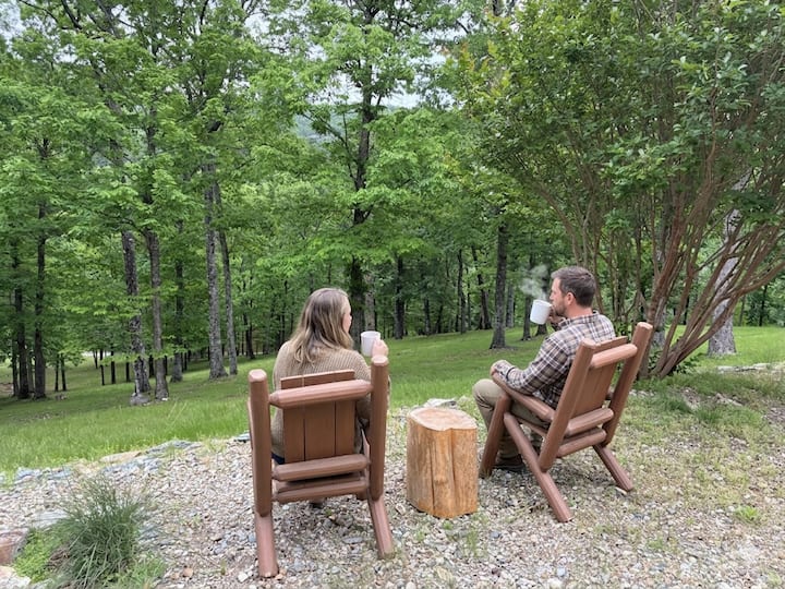 Guests enjoying coffee in the forest at Stargazing Cabin