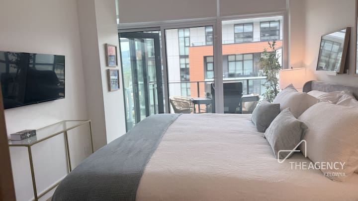 Primary bedroom with king bed, smart TV and balcony views