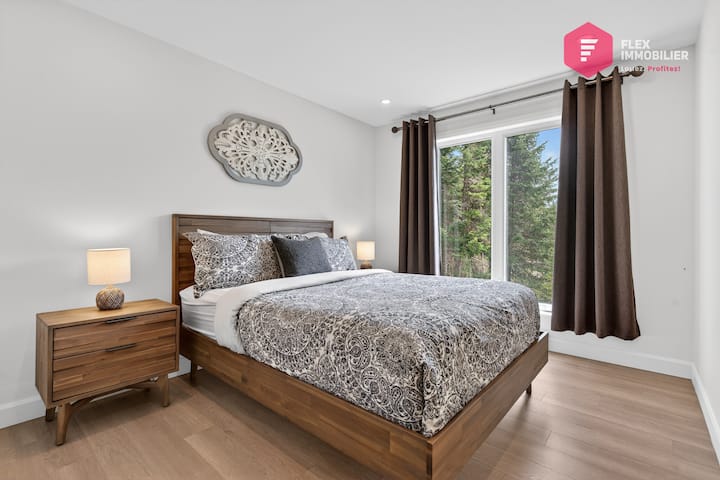 Comfortable bedroom #2 on the main floor with a queen-size bed and a double closet