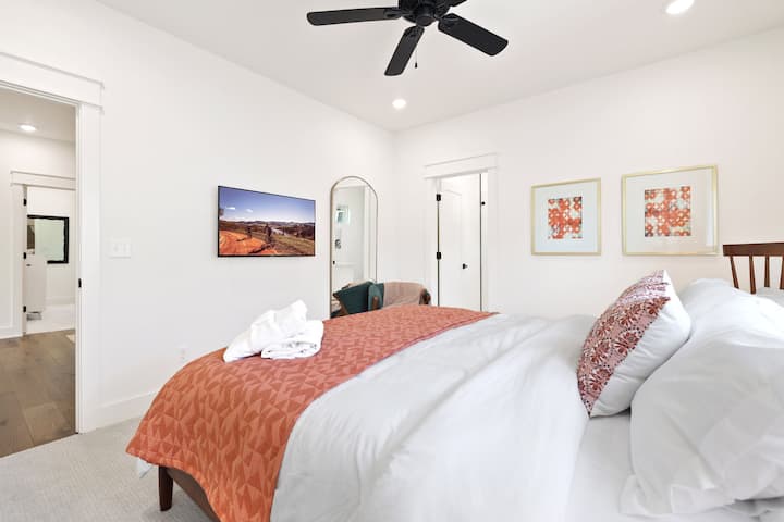 Chambre à l'étage avec très grand lit et salle de bain attenante.