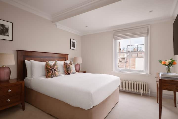 Elegant bedroom with ensuite bathroom and a 55" smart TV