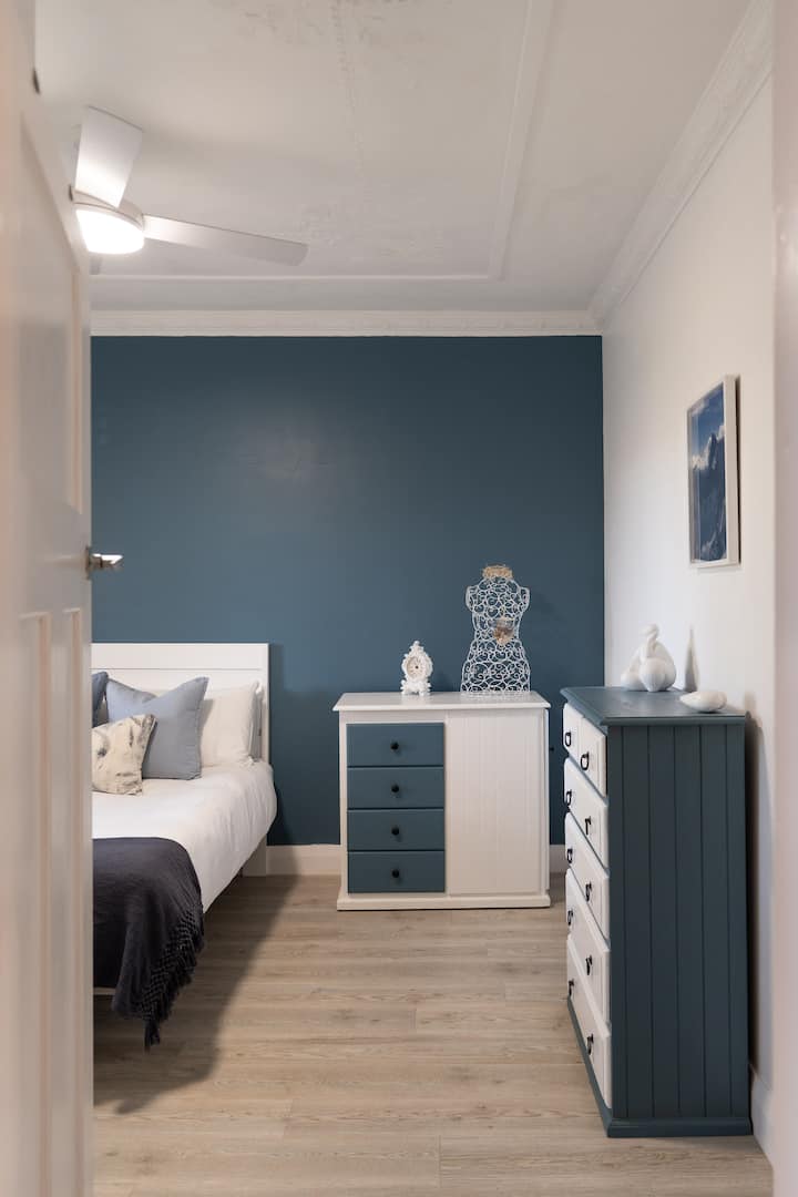 Bedroom | Rest comfortably in a calming space with soft linens, generous storage and soothing blue accents