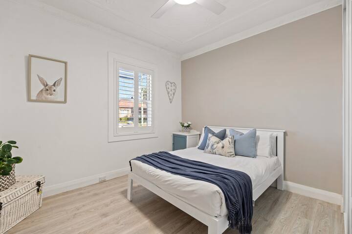 Bedroom 1 | Settle into a peaceful bedroom with fresh linens, soft neutral tones and natural light