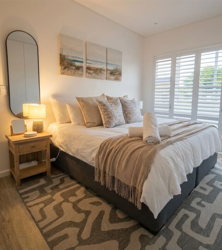 Master bedroom with doors leading to outside garden.  This bedroom has an en-suite bathroom with built in cupboards, hairdryer, safe and an electric blanket during the winter!