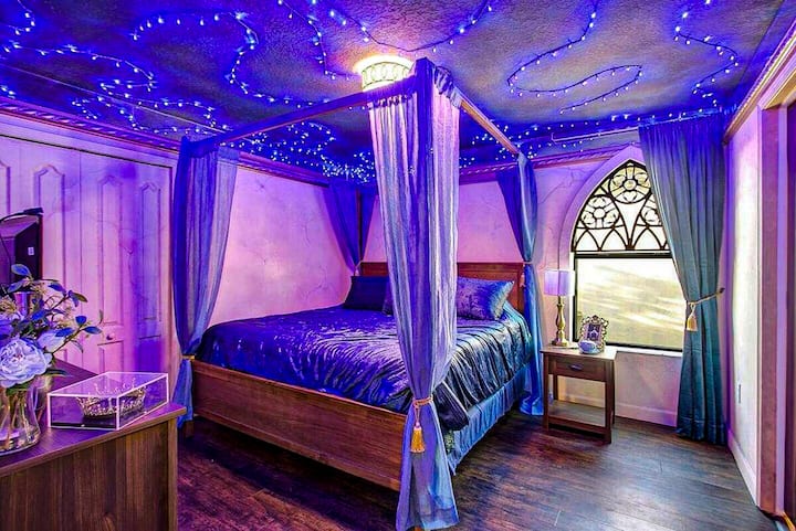 The Ravenclaw tower has a private galaxy overhead. Pull the sheer canopy closed, sink into violet velvet, and disappear until morning. The wisest choice you'll make all trip.