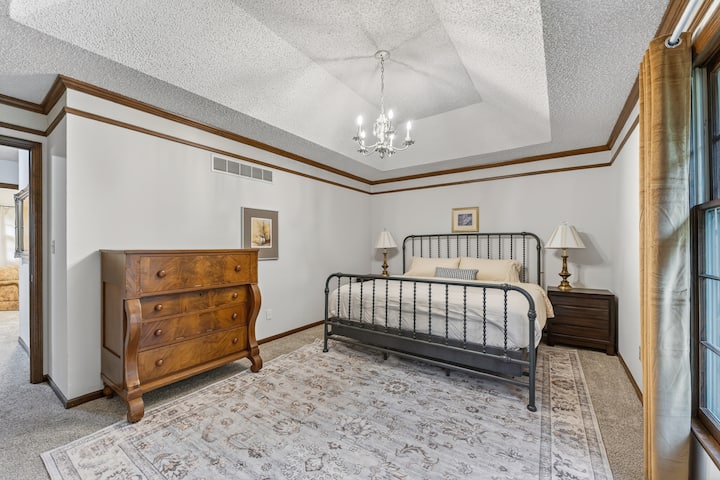 Spacious primary bedroom with elegant finishes, soft lighting, and a relaxing atmosphere for restful nights.