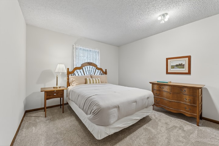 Bright and comfortable bedroom featuring clean modern design, cozy furnishings, and a peaceful atmosphere for restful stays.