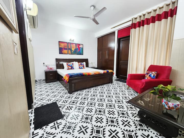 Bedroom - Spacious Bedroom with King size bed, sitting couch, attached bathroom and green balcony creating ventilation & natural light