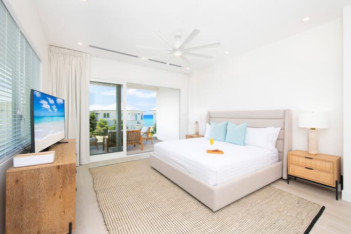 Bedroom 1 is the primary suite with HD cable TV and walkout access to a private furnished balcony.