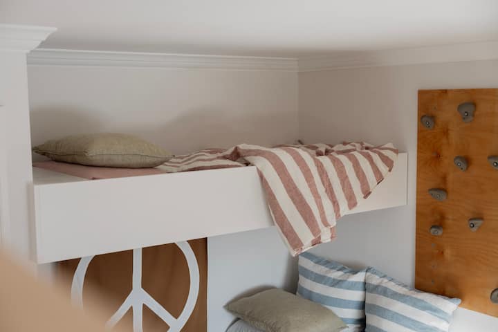 Single bunk, accessed by climbing wall, best-suited to tween or teenage guests