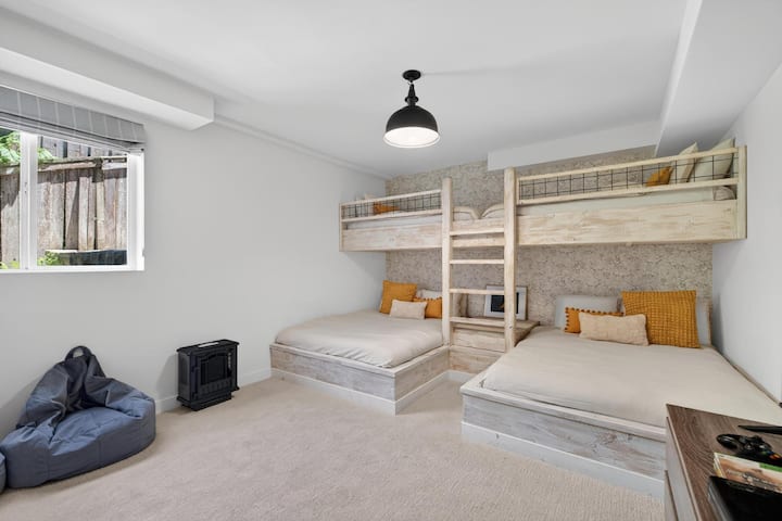 Built-in bunk room with 2 full beds, 2 twin beds, smart TV, and Xbox setup.