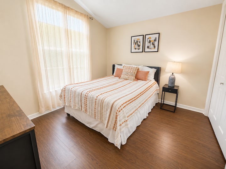 Rest comfortably in this inviting bedroom featuring a plush queen-size bed, soft linens, and a relaxing atmosphere designed for a peaceful night’s sleep.