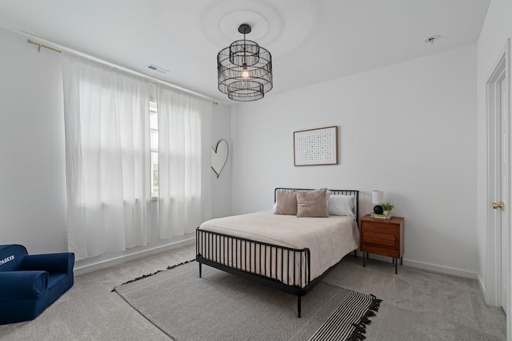 Peaceful bedroom retreat with soft natural light and modern furnishings.