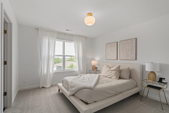 Bright and airy bedroom featuring plush bedding and a peaceful retreat feel.