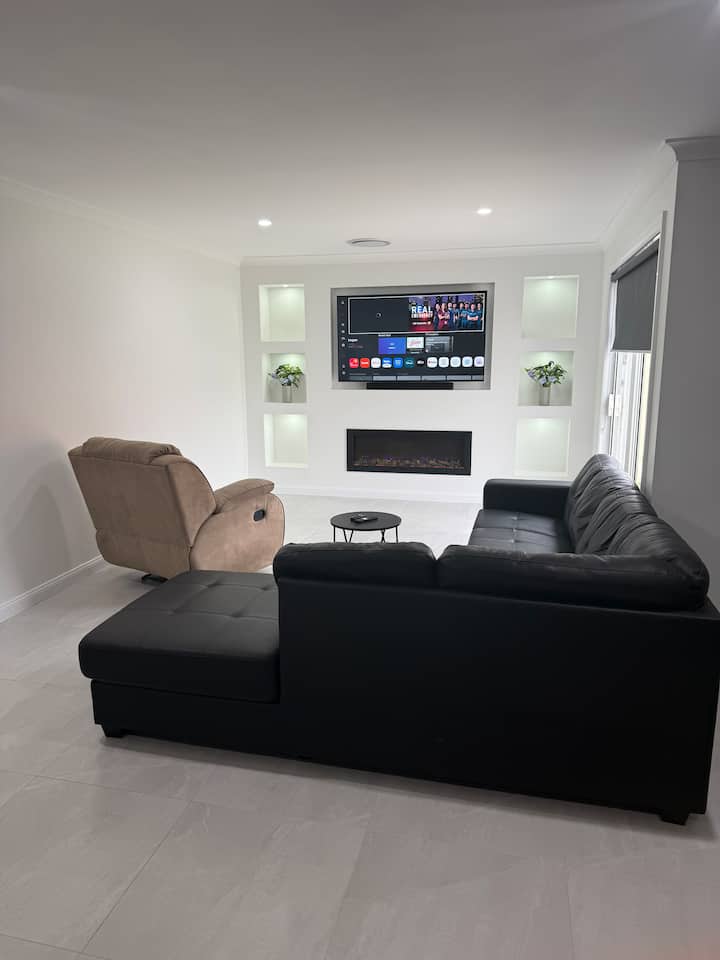 Living room with sofas, television and fireplace