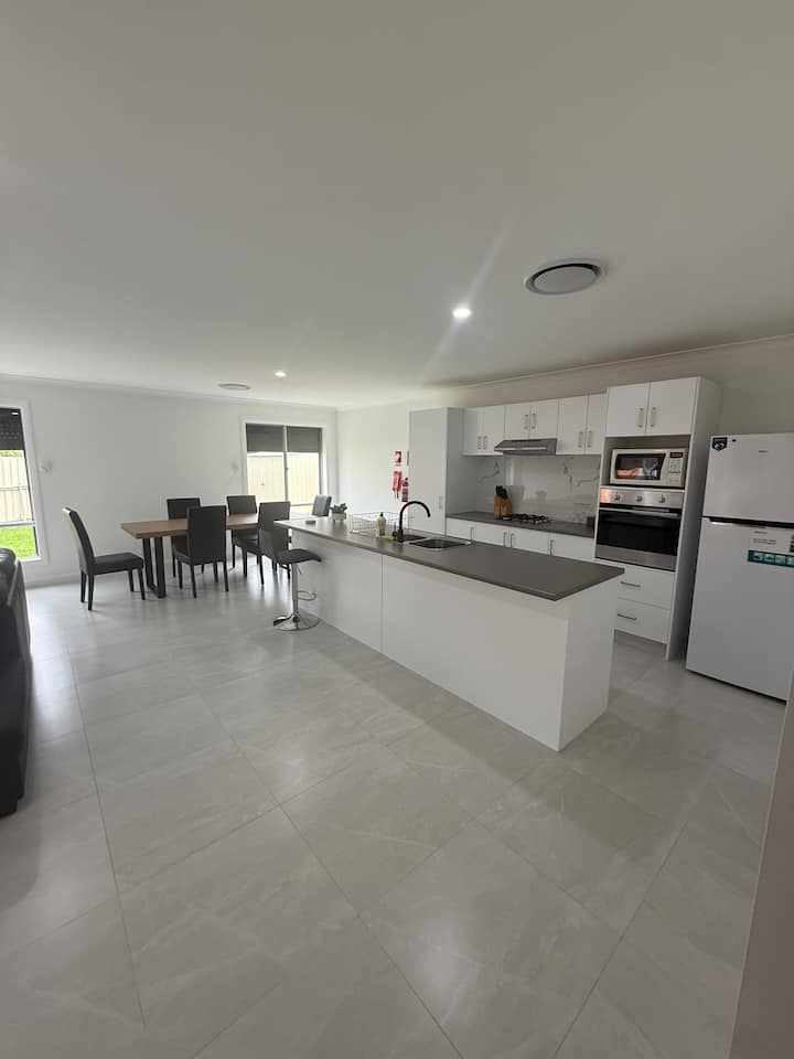 Bright kitchen with an island bench and dining table