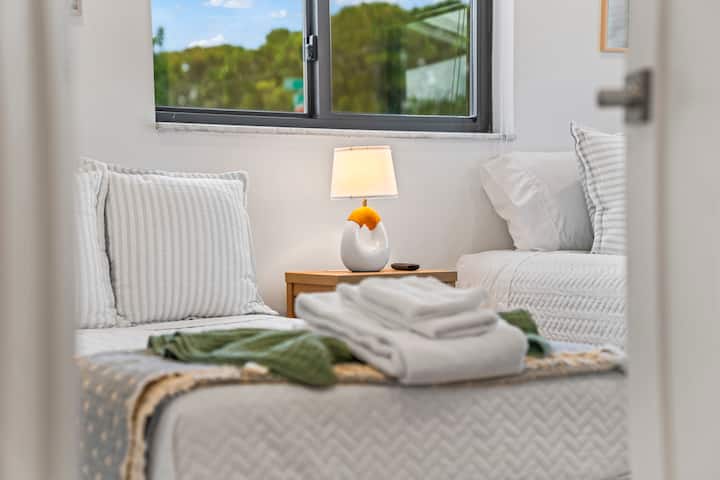 Fresh towels and a warm reading lamp are laid out and ready in the second bedroom, one more small touch guests notice the moment they walk through the door.