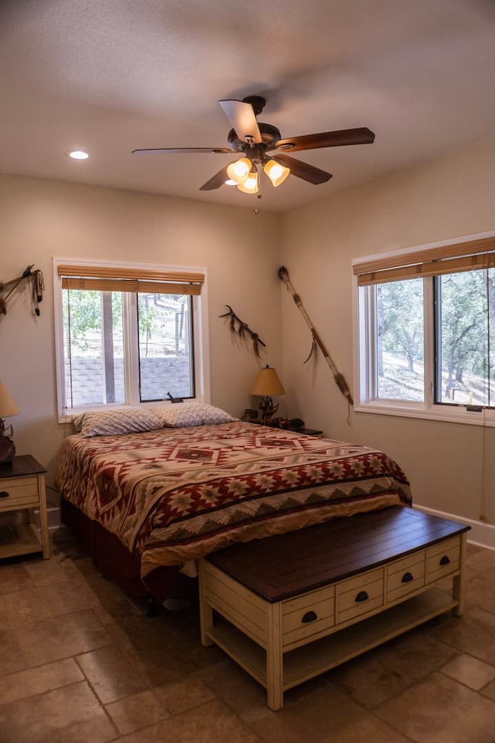Bedroom 2 featuring queen bed, fan, and AC unit