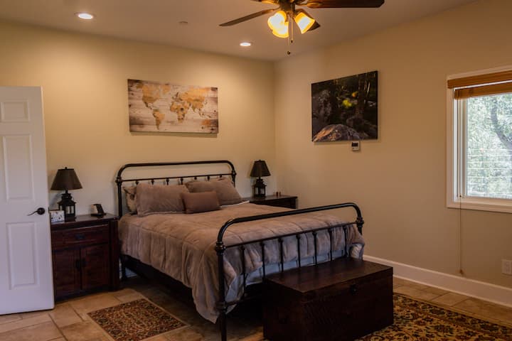 Primary Bedroom with queen bed, fan, and AC unit