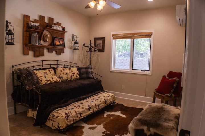 Bedroom 1 featuring single bed and single pull-out bed, fan, and AC unit