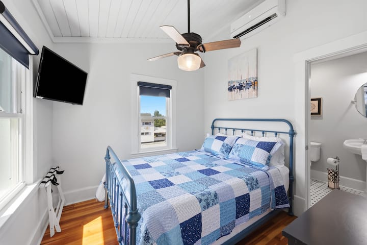 Bright and comfortable, Suite 4 features a cozy queen bed, smart TV, mini-split AC, and a private ensuite bathroom for added convenience. Located on the second floor.