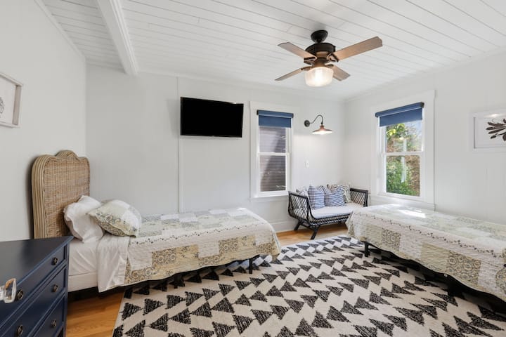 The only bedroom located on the first floor is "Suite 5" featuring 2 single beds, TV, and attached full bath.