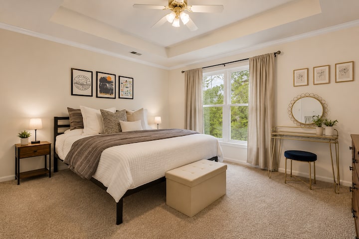Spacious primary suite with natural light and hotel style comfort.