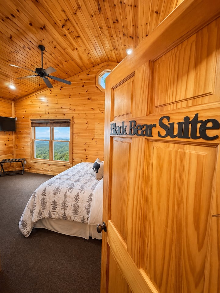 Black Bear Suite king bedroom entrance with mountain views, private bathroom access, and rustic Smoky Mountain décor.