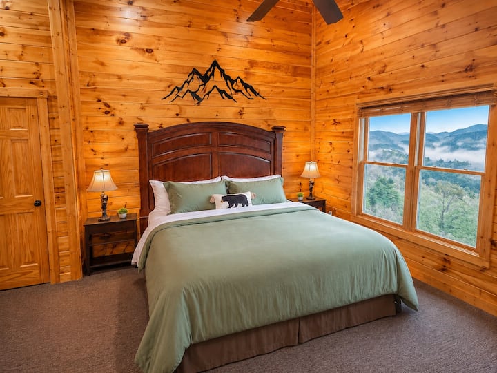 Evergreen Suite king bedroom with mountain views, cozy cabin décor, and private bathroom access at Views Forever in Gatlinburg.