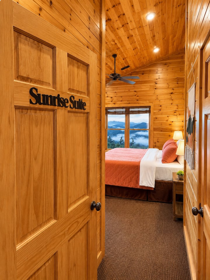 Sunrise Suite king bedroom entrance with cozy cabin wood interiors and Smoky Mountain views at Views Forever Gatlinburg cabin.