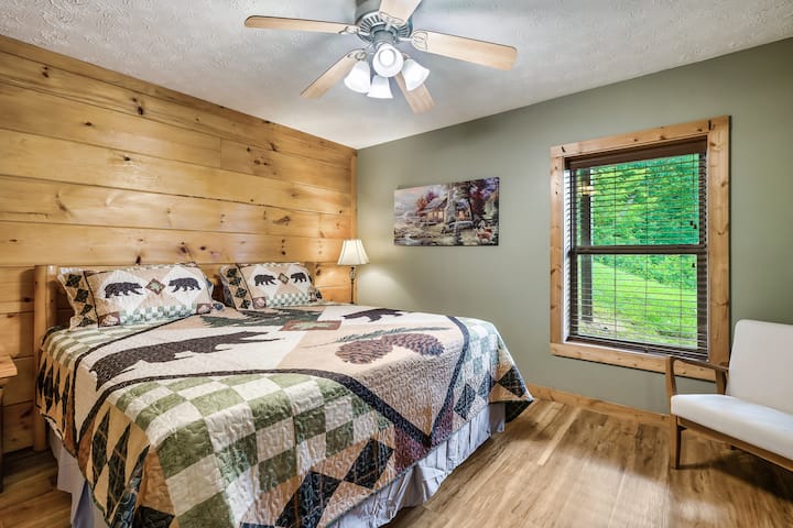 Relax and recharge in this comfortable king bedroom featuring a Smart TV and peaceful cabin charm.