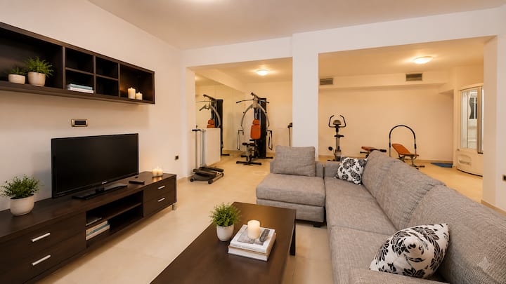 Lower Level - Cozy TV & movie lounge with comfortable seating for relaxing after a day of exploring Crete